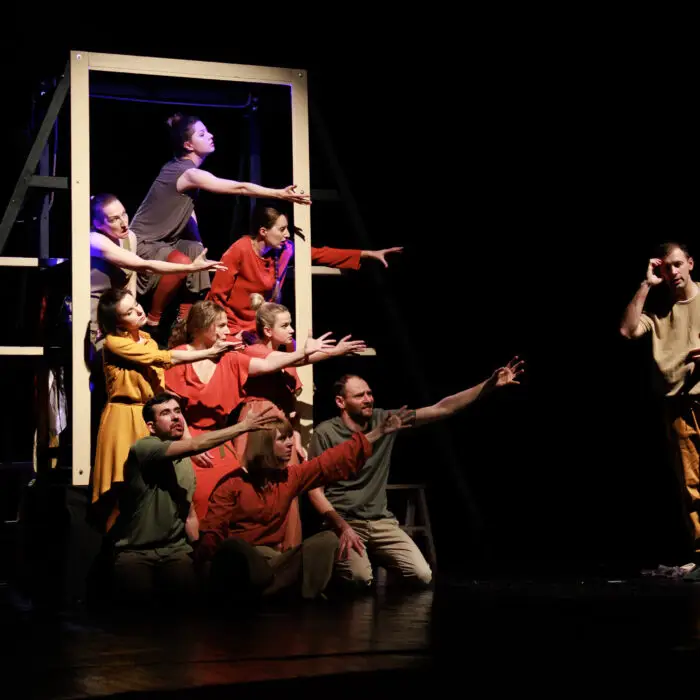 Actors and actresses perform a modern performance on the stage of the theater.