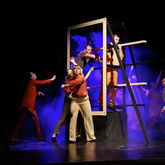 Actors and actresses perform a modern performance on the stage o