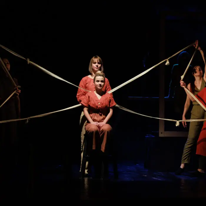 Actors and actresses perform a modern performance on the stage of the theater.